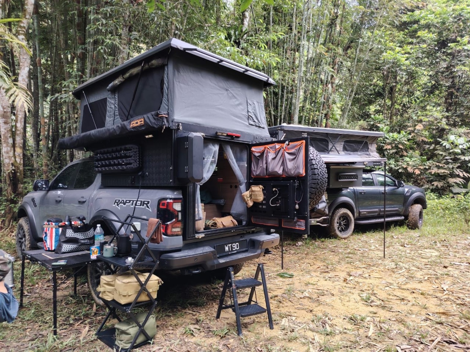 Campers gathered at a forest campsite