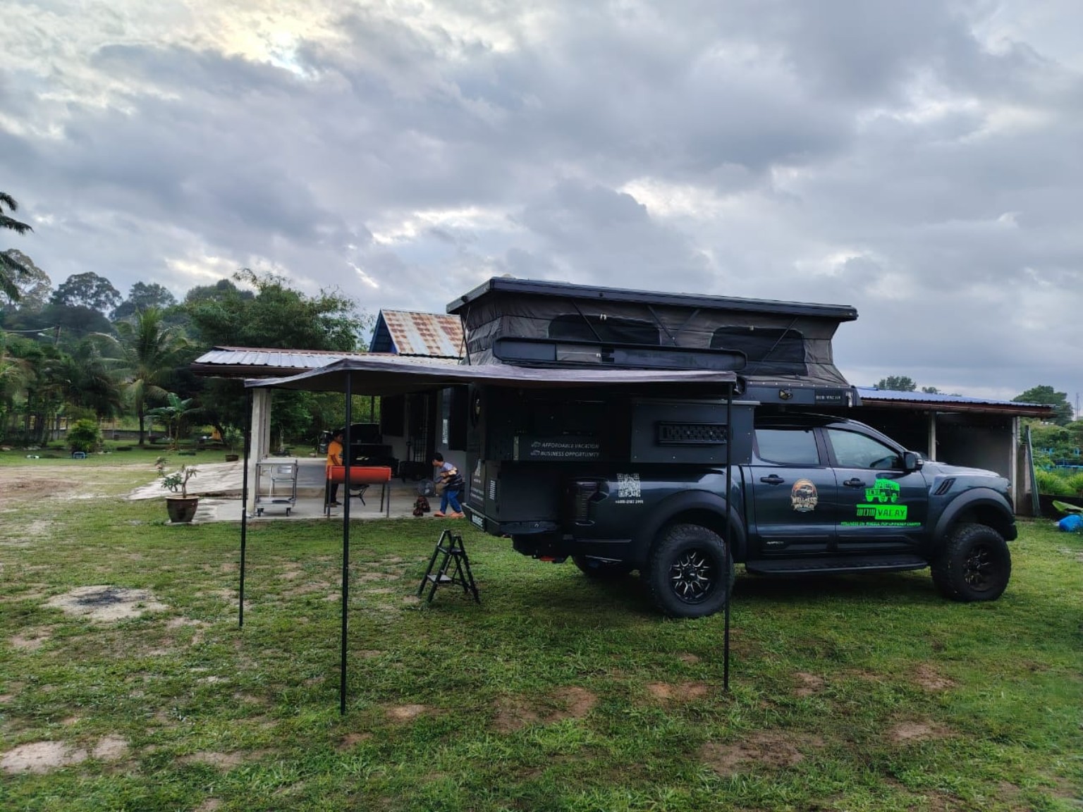 Truck camper at a grassy campsite
